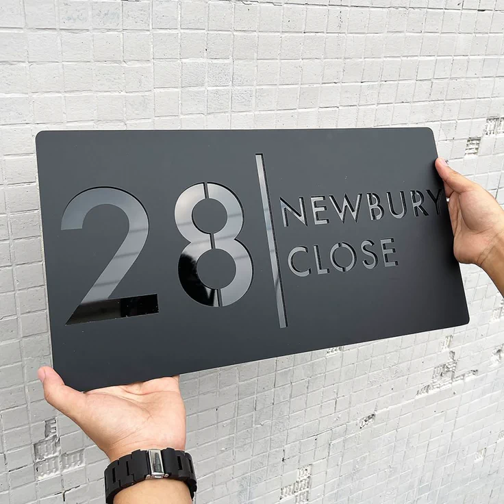 Grey acrylic address sign reading 28 Newbury Close