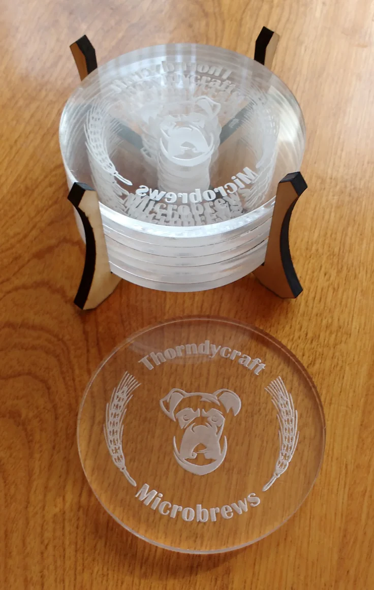 Clear acrylic coasters engraved with a brewery logo