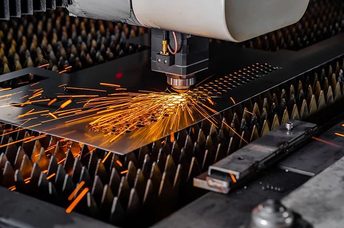 Laser cutting steel plate with a spray of sparks