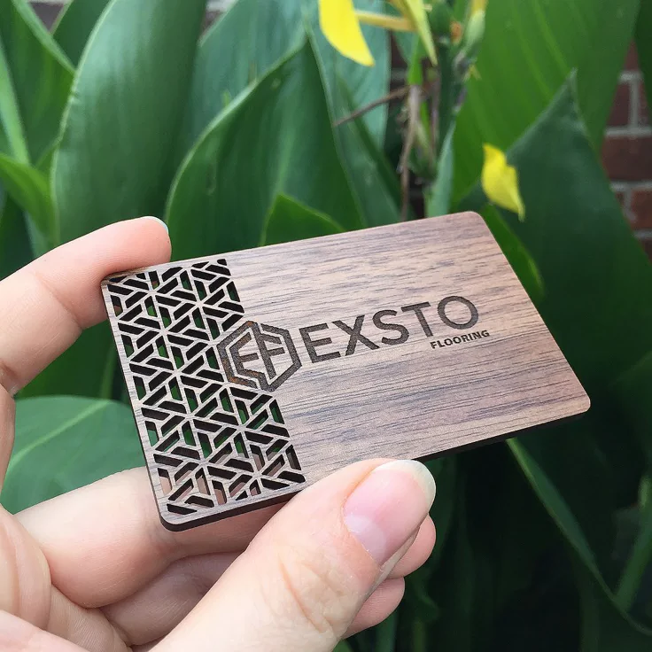 Walnut wooden business card with a laser-cut geometric pattern