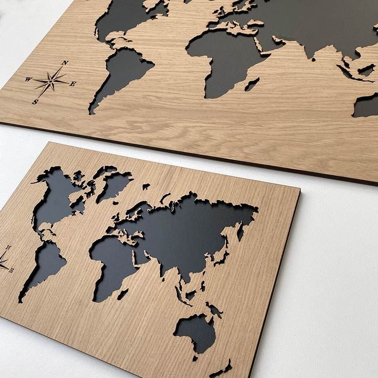 Laser-cut wooden world map wall art with an inlaid dark backing